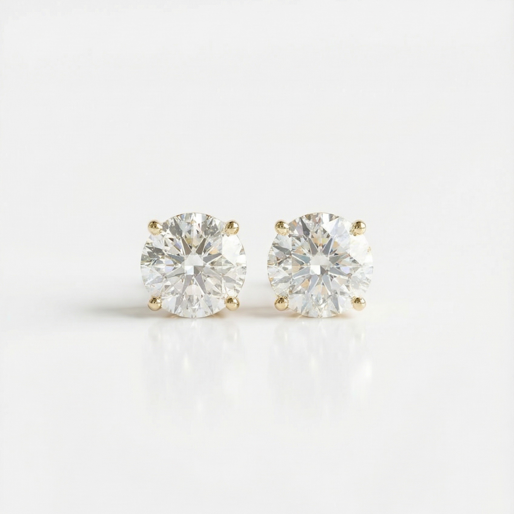 Pair of diamond stud earrings on a white background
