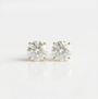 Pair of diamond stud earrings on a white background