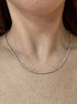 Necklace with small stones on a person's neck
